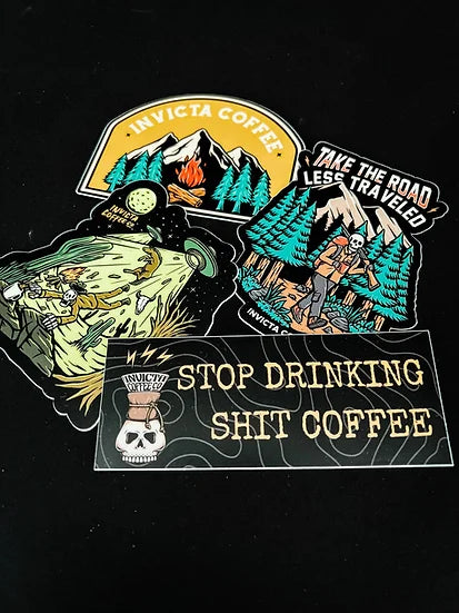 A four pack of stickers featuring mountains, aliens, hiking, and a stop drinking shit coffee text. 